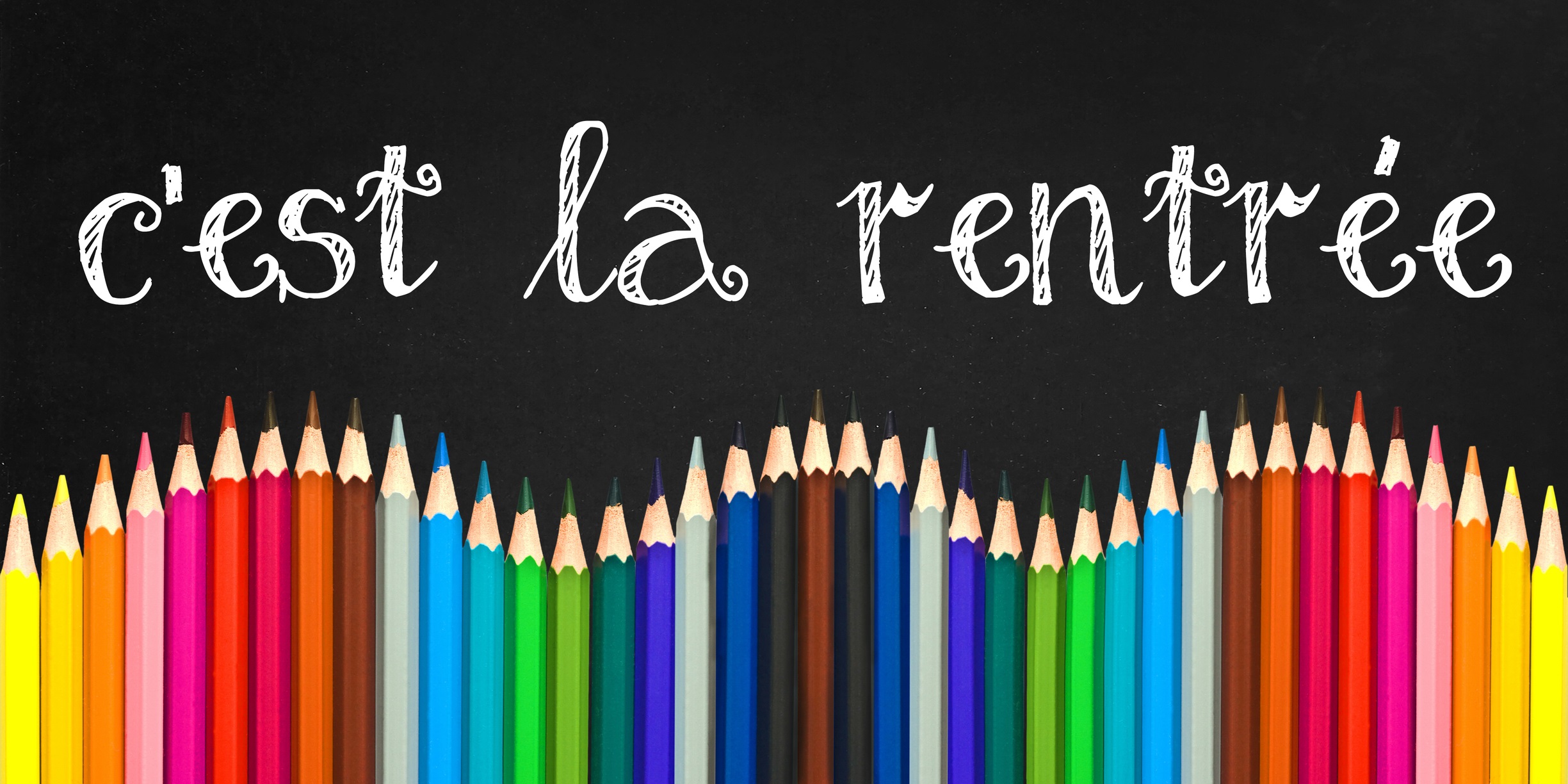 C'est la rentree (meaning Back to schoo in french) written on a black board background with a wave of colorful wooden pencils